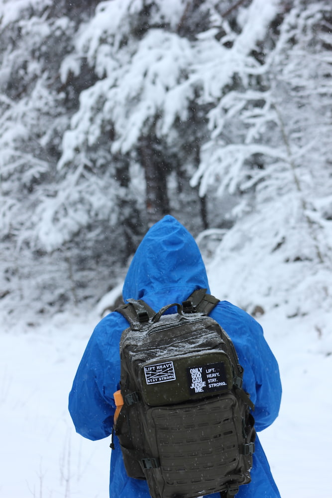 man in blue jacket hiking